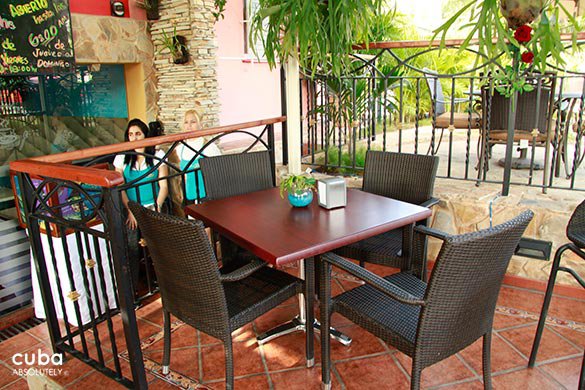 table at restaurant with black chairs in an open space © Cuba Absolutely, 2014