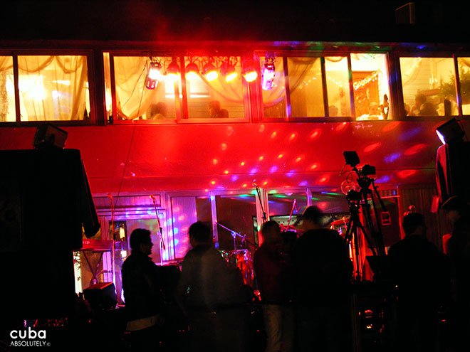 people at a disco with red lights © Cuba Absolutely, 2014