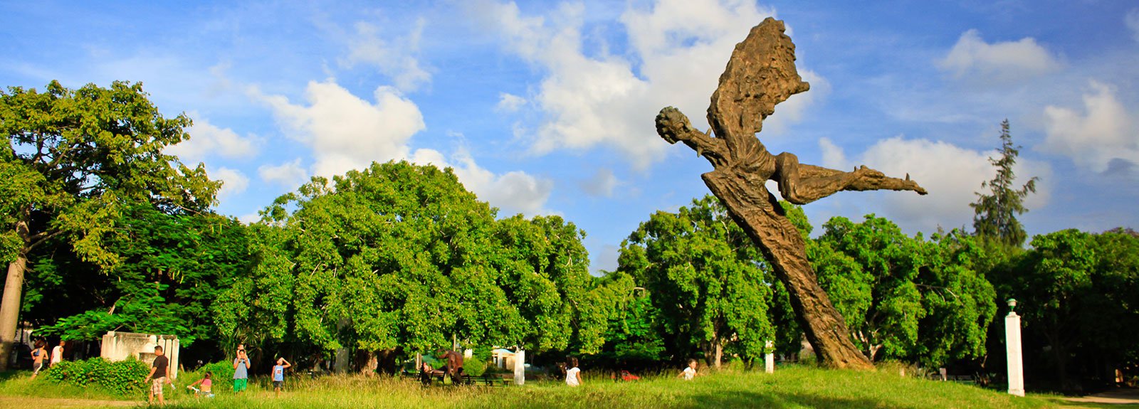 Iron statue of an angel on the right in a park