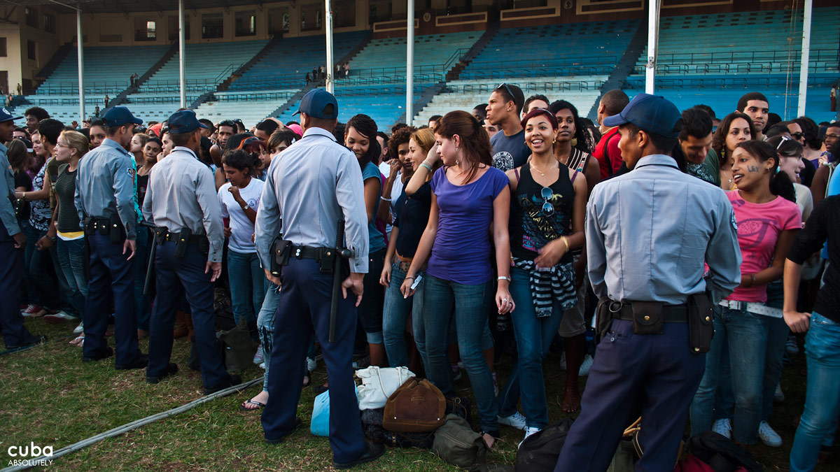 Sometimes, police officers help control the overexcited crowd. Havana, Cuba